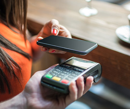 Woman using Apple Pay with smartphone