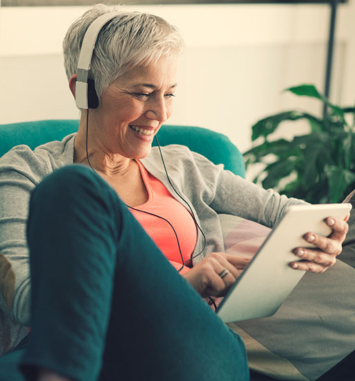 Happy senior woman on tablet