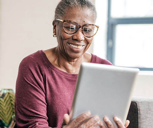 Happy elderly woman using mobile banking