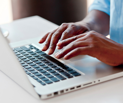 Close up hands typing on laptop